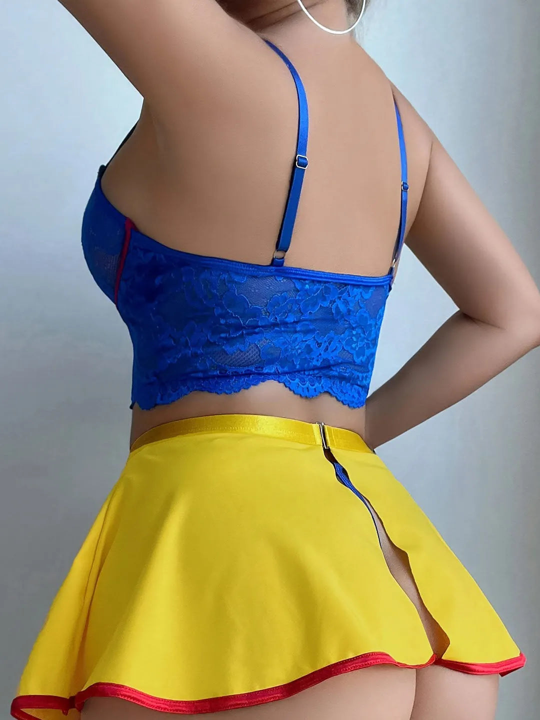 Scarlet Sapphire lingerie back view with blue lace crop top and yellow mini skirt