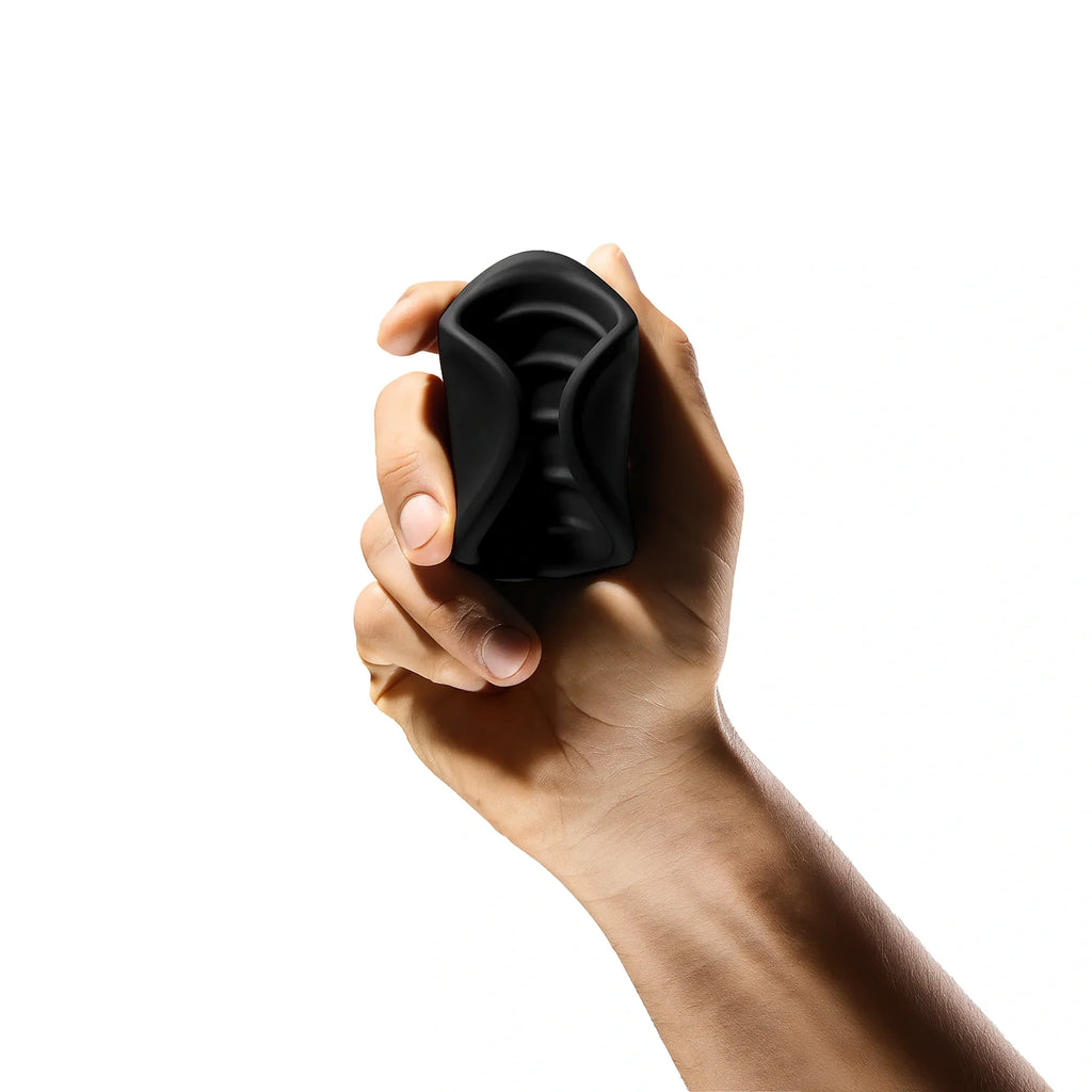 Vortex Stroker – black silicone men’s wellness tool held in hand, compact and discreet design for stress relief and relaxation.